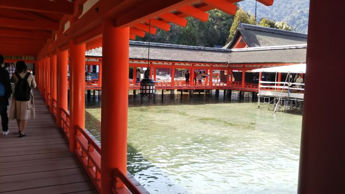 Inside Itsukushima Shrine during high tide, surrounded by the sea