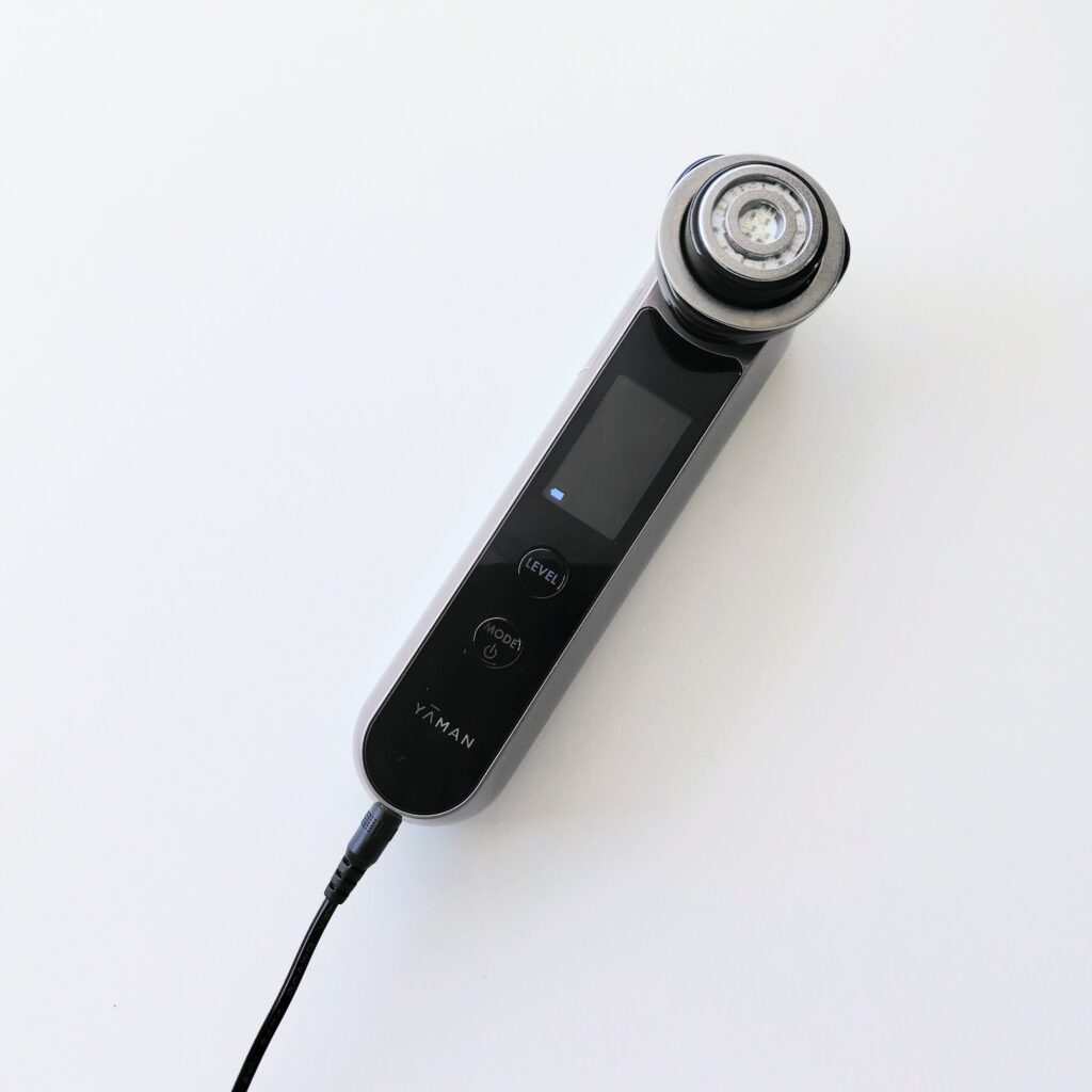 A beauty device being charged as part of a repeated charge-and-run cycle