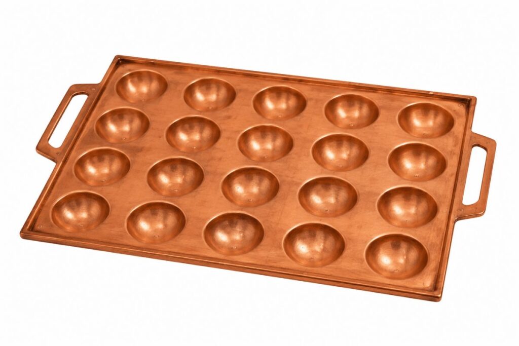 Akashiyaki cooking plate with shallow round molds used for making traditional egg batter dumplings