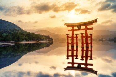 Evening view of the Itsukushima Torii reflected on the calm sea in Miyajima
